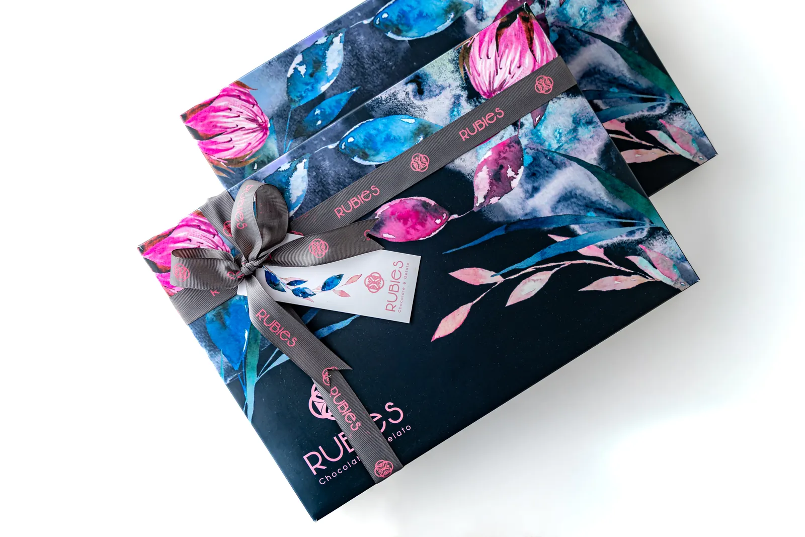 Two navy Rubies gift boxes with watercolor florals, branded ribbon and hang tag